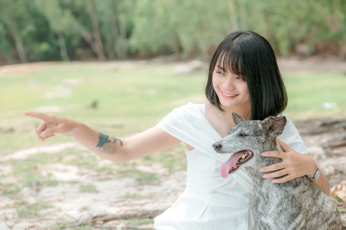 A woman and her dog sharing a happy moment in a park
